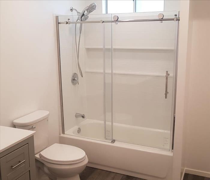 White painted walls, shower and tub have been installed , toilet and vanity installed. 