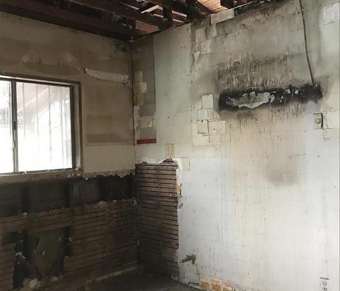 Wood studs, fire soot on walls , window, drywall removed