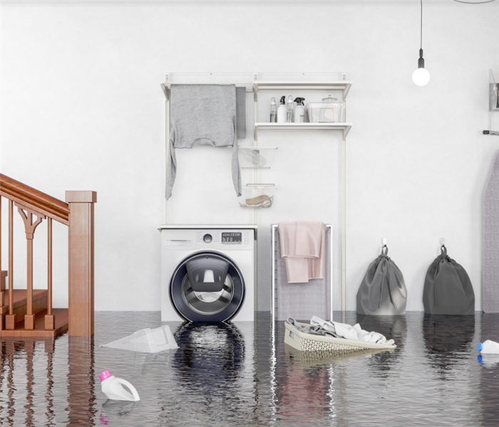a flooded laundry area with water covering the floor